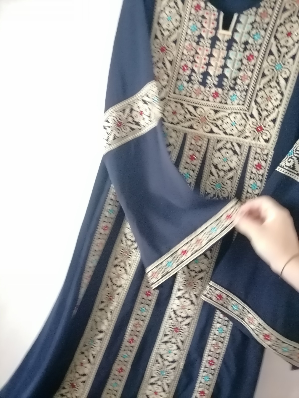 Navy thobe with old Arabic embroidery, distinctive with a floral design