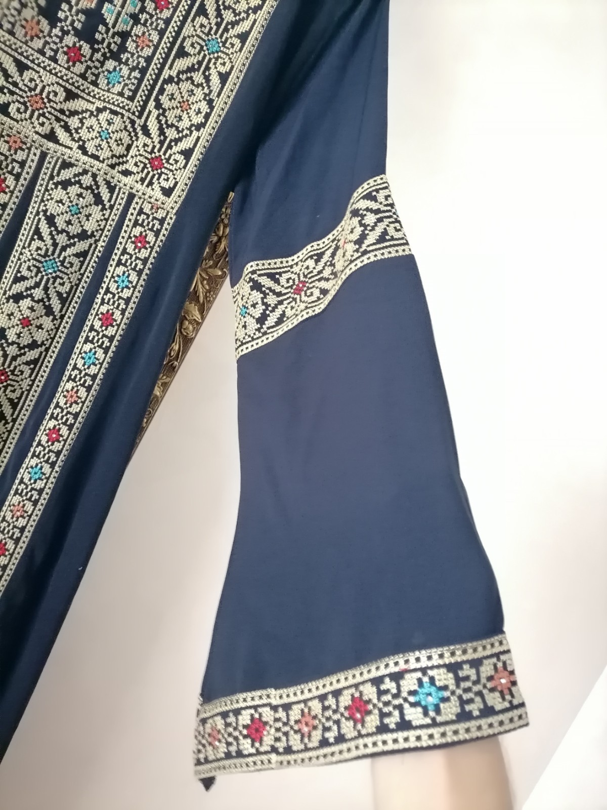 Navy thobe with old Arabic embroidery, distinctive with a floral design