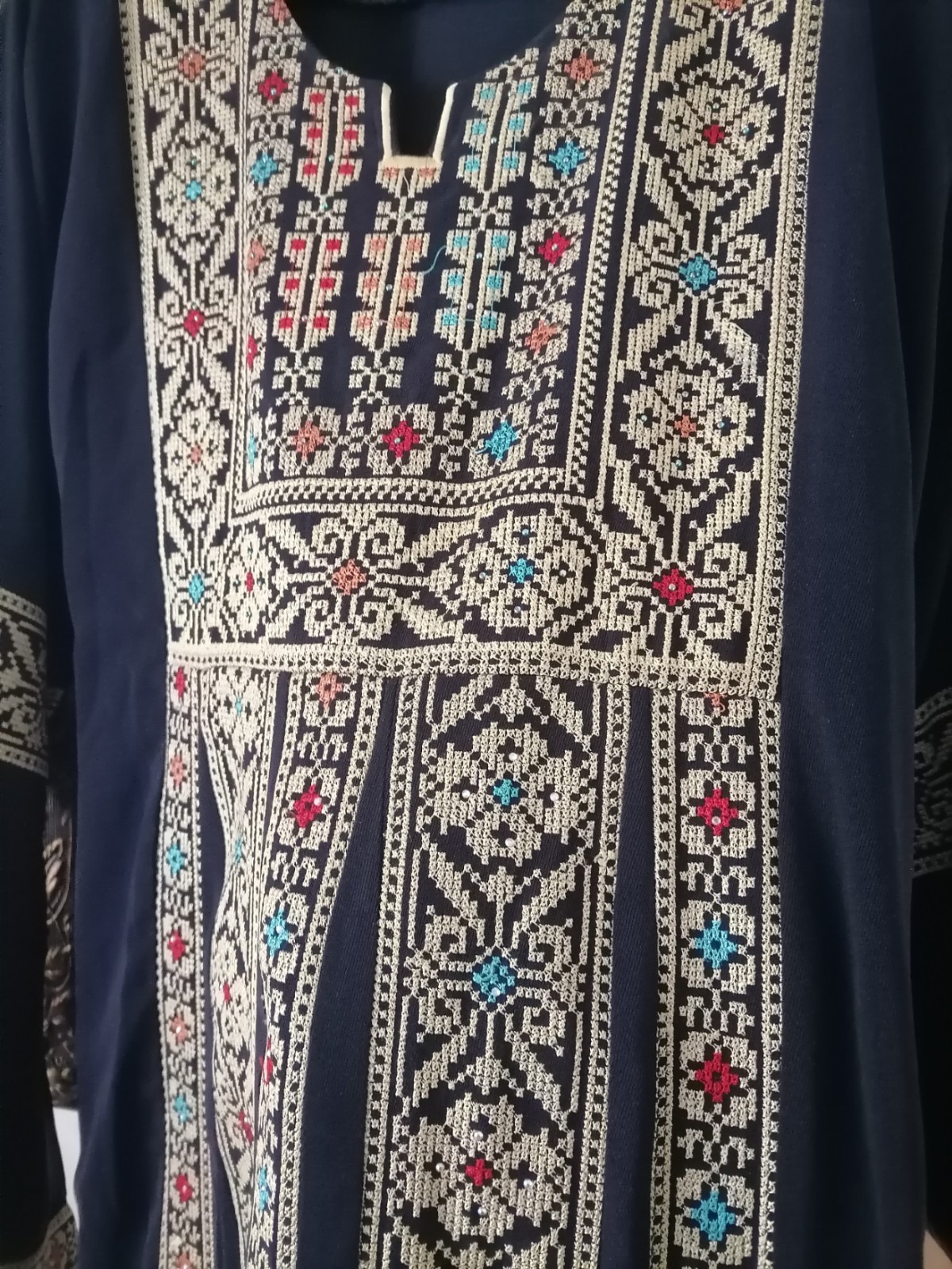 Navy thobe with old Arabic embroidery, distinctive with a floral design