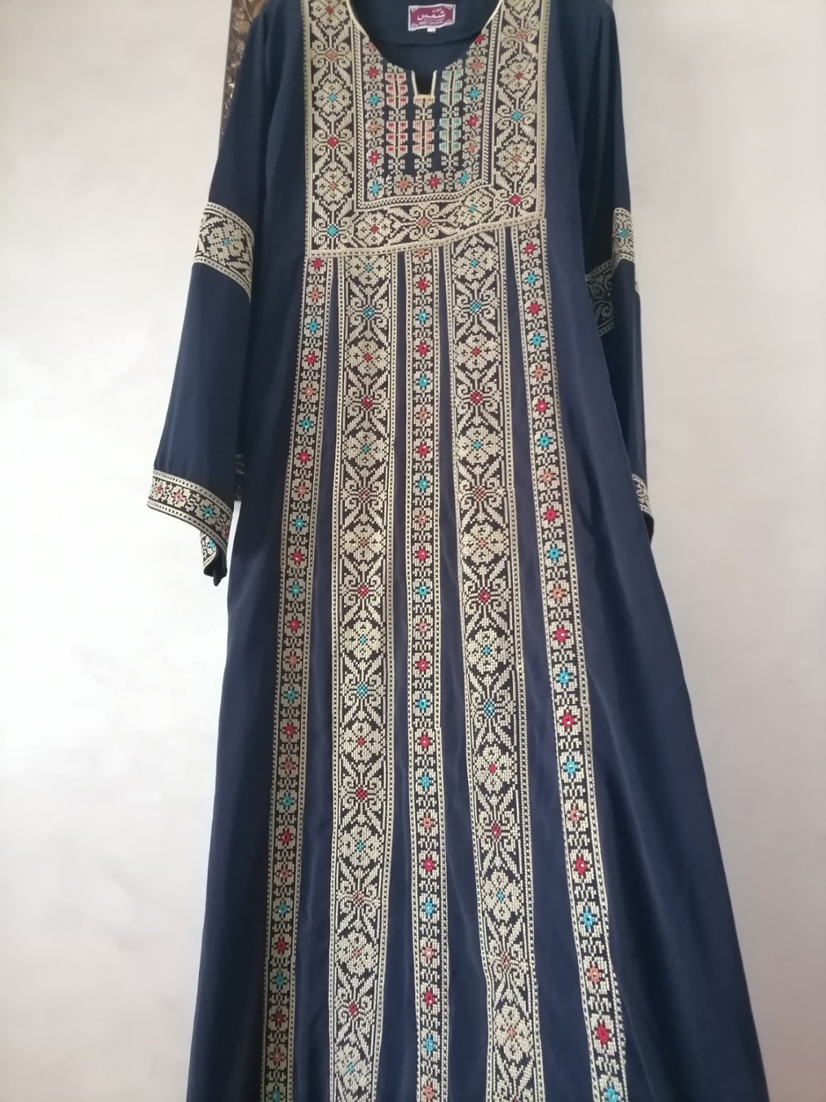 Navy thobe with old Arabic embroidery, distinctive with a floral design