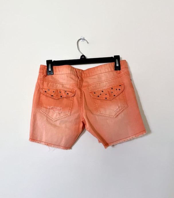 DREAM OUT LOUD distressed orange shorts by Selena Gomez