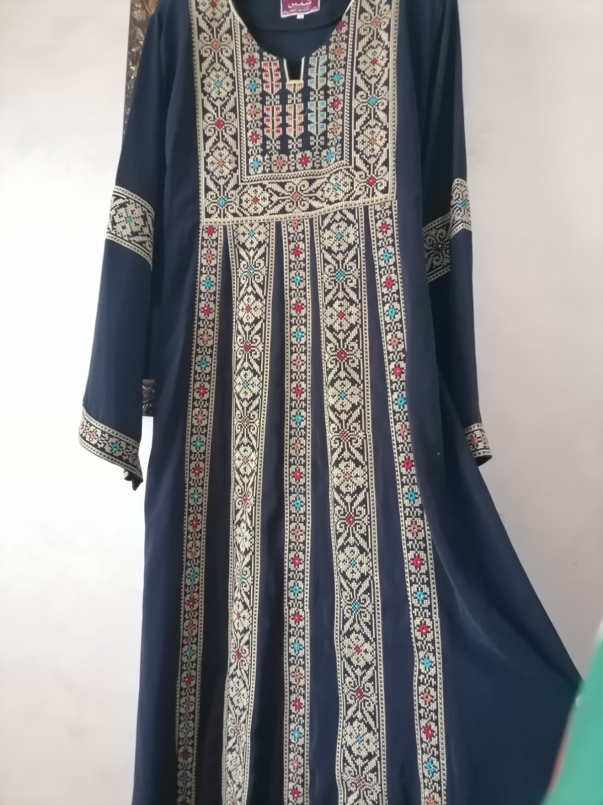 Navy thobe with old Arabic embroidery, distinctive with a floral design