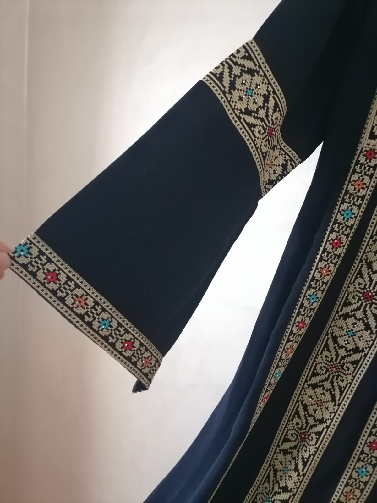 Navy thobe with old Arabic embroidery, distinctive with a floral design