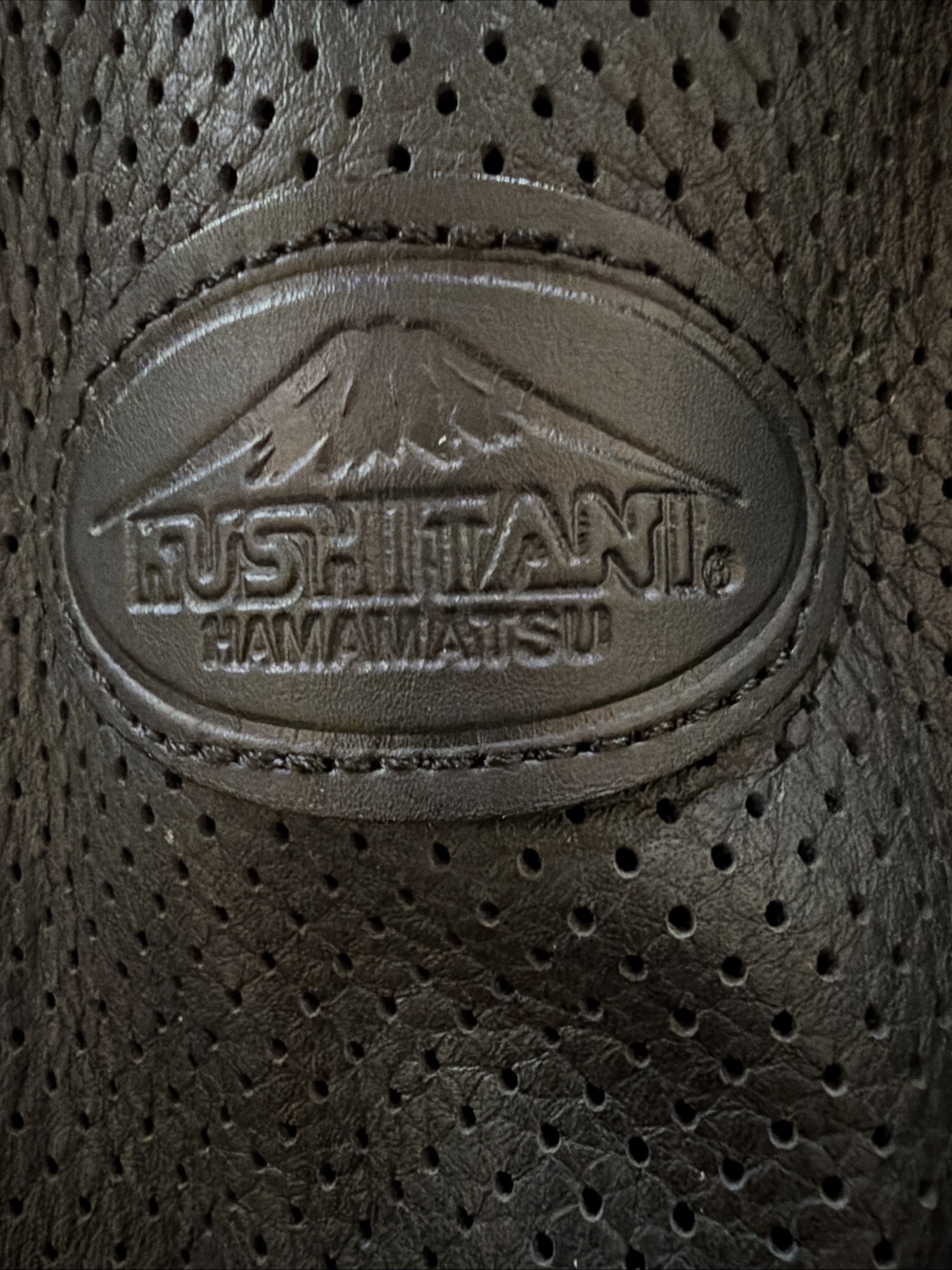 Kushitani leather biker jacket features a perforated design for airflow.